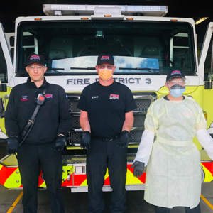 Fire District 3. Three people in front of Engine.