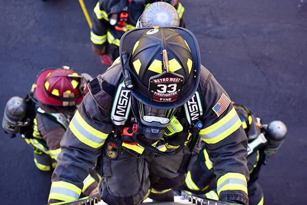 Metro West firefighter climbing